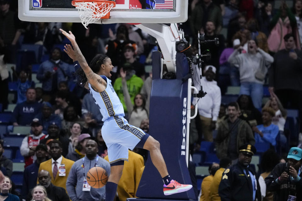 Memphis Grizzlies guard Ja Morant slam dunks in the final seconds of overtime during an NBA basketball game against the New Orleans Pelicans in New Orleans, Tuesday, Dec. 26, 2023. The Grizzlies won 116-115. (AP Photo/Gerald Herbert)