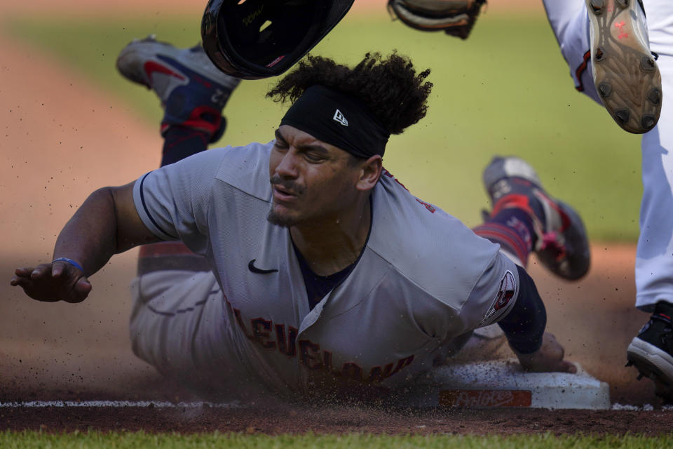 Cleveland Guardians' Josh Naylor steals second base under the tag of Baltimore Orioles third baseman Gunnar Henderson during the fifth inning of a baseball game, Wednesday, May 31, 2023, in Baltimore. The Guardians won 12-8. (AP Photo/Julio Cortez)