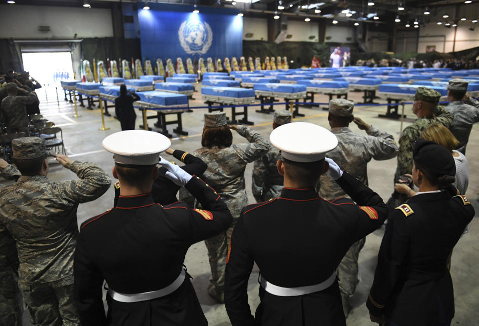 U.S. soldiers salute during a repatriation ceremony for the remains of U.S. soldiers who were killed in the Korean War and collected in North Korea, at the Osan Air Base in Pyeongtaek, South Korea, Wednesday, Aug. 1, 2018. North Korea handed over 55 boxes of the remains last week as part of agreements reached during a historic June summit between its leader Kim Jong Un and U.S. President Donald Trump. (Jung Yeon-je/Pool Photo via AP)