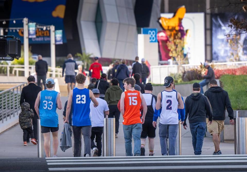 Fans walk to Golden 1 Center during the first day of NCAA Regional men’s basketball games in Sacramento.