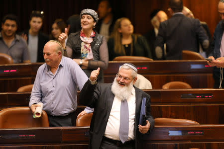 Deputy Minister in the Ministry of Defense, Eli Ben-Dahan (front) and other Israeli lawmakers gesture as they attend a vote on a bill at the Knesset, the Israeli parliament, in Jerusalem February 6, 2017. REUTERS/Ammar Awad