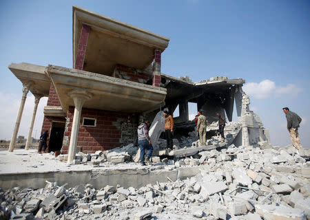 Sunni Arab fighters gather at a house, which the residents of the village said belonged to a man who joined the Islamic State militants and was destroyed in an explosion, in Rfaila village in south of Mosul, Iraq, February 17, 2017. REUTERS/Khalid al Mousily