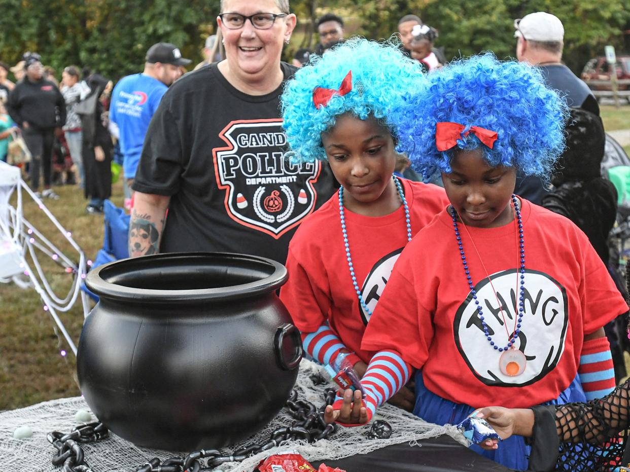 Kim Strickland, left, follows her friends Alyssa and Alaina Hendrix of Anderson, dressed as Thing 1 and Thing 2, during the Anderson Lights of Hope Boograss Trunk or Treat, S.C. Tuesday, October 24, 2023.