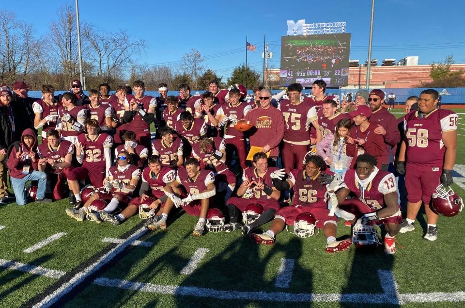 O'Neill players celebrate their 41-22 victory over Warrensburg in the Class C football state semifinal at Middletown  High School Nov. 26, 2022. .