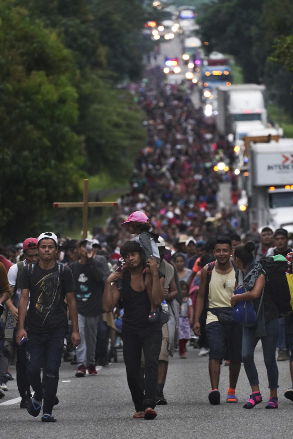 Migrants walk along the highway toward the municipality of Escuintla, Chiapas state, Mexico, early Thursday, Oct. 28, 2021, as they continue their journey toward the northern states of Mexico and the U.S. border. (AP Photo/Marco Ugarte)