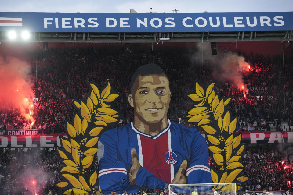 A giant painting depicting PSG's Kylian Mbappe is displayed before the French League One soccer match between Paris Saint-Germain and Toulouse at the Parc des Princes stadium in Paris, Sunday, May 12, 2024. (AP Photo/Christophe Ena)