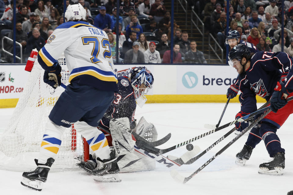 Columbus Blue Jackets' Jet Greaves, center, makes a save against St. Louis Blues' Justin Faulk, left, during the first period of an NHL hockey game Friday, Dec. 8, 2023, in Columbus, Ohio. (AP Photo/Jay LaPrete)