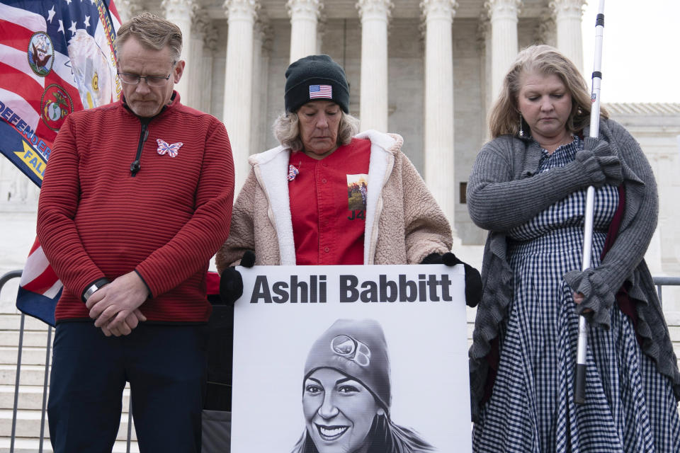 Micki Witthoeft, center, mother of Ashli Babbitt, the woman fatally shot by police inside the U.S. Capitol during the Jan. 6, 2021, riot, joins protesters outside of the Supreme Court on the second anniversary of the Jan. 6, assault on the U.S. Capitol, in Washington, Friday, Jan. 6, 2023. Witthoeft was arrested in Washington on Friday after refusing to get out of the street during a demonstration on the two-year anniversary, police said. (AP Photo/Jose Luis Magana)