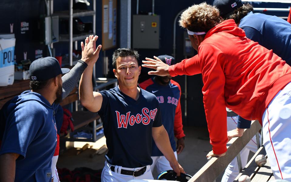 Worcester's Rob Refsnyder gets high-fives in the dugout after scoring on Ryan Fitzgerald's single Wednesday at Polar Park.