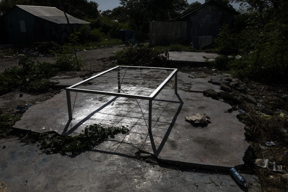 An abandoned bed frame sits in the La Piste neighborhood, in Port-au-Prince, Haiti, Friday, Sept. 17, 2021. Gunmen laid siege to the encampment in June, a neighborhood of deaf and disabled Haitians relocated there by the International Red Cross after the 2010 earthquake leveled the capital. This time it was the police leading an assault at dusk. (AP Photo/Rodrigo Abd)
