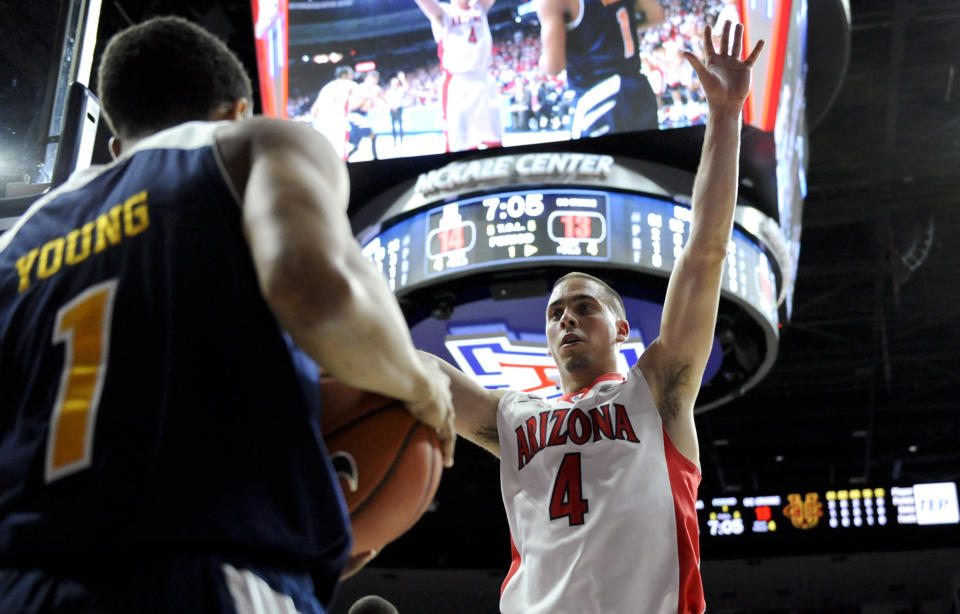 Nov 19, 2014; Tucson, AZ, USA; Arizona Wildcats guard T.J. McConnell (4) defends an inbound pass by UC Irvine Anteaters guard Alex Young (1) during the first half at McKale Center. 