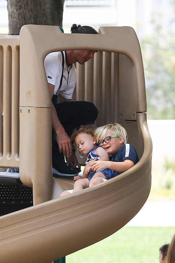 Zuma cuddles little brother Apollo on the slippery slide during the family’s day out in West Hollywood on May 30th.