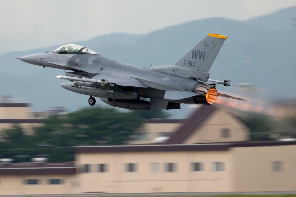 An F-16 Fighting Falcon with the 35th Fighter Wing departs Yokota Air Base, Japan, with its afterburner on.
