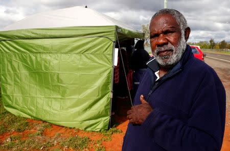 Gordon Sullivan, from a local Aboriginal community, poses near a remote voting station after he voted in the western New South Wales outback town of Enngonia, Australia, June 22, 2016. REUTERS/David Gray