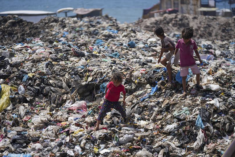 Palestinian kids sort through trash at a landfill in Nuseirat refugee camp, Gaza Strip.