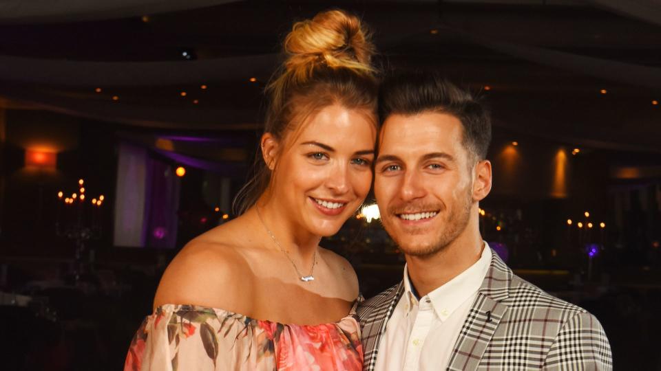 Gemma Atkinson in floral dress hugging Gorka Marquez in tweed suit