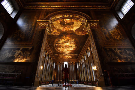 A gallery assistant poses during the reopening of The Painted Hall, Old Royal Navy College in London, Britain, March 20, 2019. REUTERS/Dylan Martinez