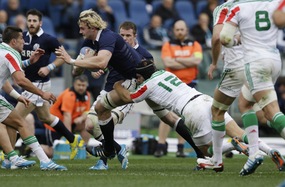 Scotland's Richie Gray, left, is tackled by Italy's Gonzalo Garcia during a Six Nations rugby union international match between Italy and Scotland, Saturday, Feb. 22, 2014. (AP Photo/Andrew Medichini)