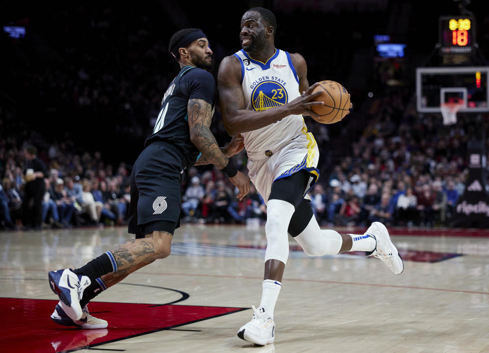 Golden State Warriors forward Draymond Green drives to the basket past Portland Trail Blazers guard Gary Payton II during the first half of an NBA basketball game in Portland, Ore., Wednesday, Feb. 8, 2023. (AP Photo/Craig Mitchelldyer)
