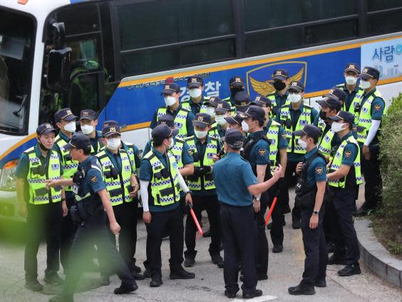 Police officers arrive to search for Park Won-soon in Seoul (Kim Ju-sung/Yonhap via AP)