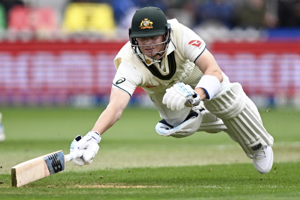 Australia's Steve Smith dives to make his ground while batting against New Zealand on the first day of their cricket test match in Wellington, New Zealand, Thursday, Feb. 29, 2024. (Andrew Cornaga/Photosport via AP)