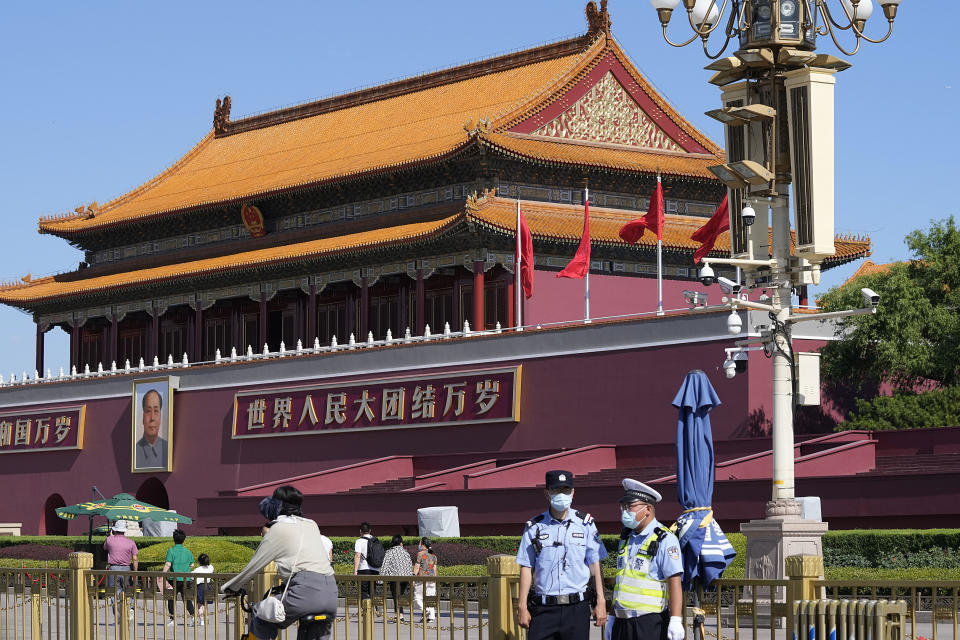 Chinese policemen stand on duty near Tiananmen Gate on the 32nd anniversary of a deadly crackdown on pro-democracy protests in Beijing on Friday, June 4, 2021. Commemorations of the June 4, 1989 crackdown on student-led pro-democracy protests centered on Beijing's Tiananmen Square were especially muted Friday amid pandemic control restrictions and increasing political repression. (AP Photo/Ng Han Guan)