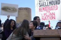 Ohlone elder Ruth Orta, bottom center, hugs Melissa Nelson, chair of the board of directors of the Sogorea Te' Land Trust, at a news conference in Berkeley, Calif., Wednesday, March 13, 2024. Berkeley's City Council voted unanimously Tuesday, March 12, 2024, to adopt an ordinance giving the title of the land to the Sogorea Te' Land Trust, a women-led, San Francisco Bay Area collective that works to return land to Indigenous people and that raised the funds needed to reach the agreement. (AP Photo/Jeff Chiu)