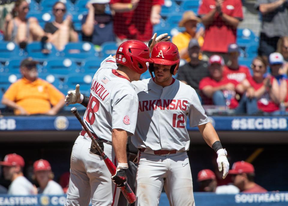 May 27, 2022; Hoover, AL, USA;  Arkansas right fielder Chris Lanzilli (18) congratulates Arkansas catcher Michael Turner (12) after Turner’s home run against Florida in the SEC Tournament at the Hoover Met in Hoover, Ala., Thursday. Mandatory Credit: Gary Cosby Jr.-The Tuscaloosa News