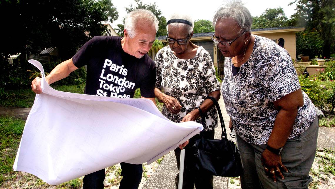 Builder Tom O’Brien shows home plans to Mary Hayes, 91, and her daughter Deloris Hayes, both of St. Petersburg, on June 7, 2016, in the Palmetto Park neighborhood of St. Petersburg.