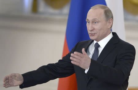 Russian President Vladimir Putin gestures as he chairs a meeting with members of the presidential council for inter-ethnic relations and the Russian language at the Kremlin in Moscow, Russia, May 19, 2015. REUTERS/Alexander Nemenov