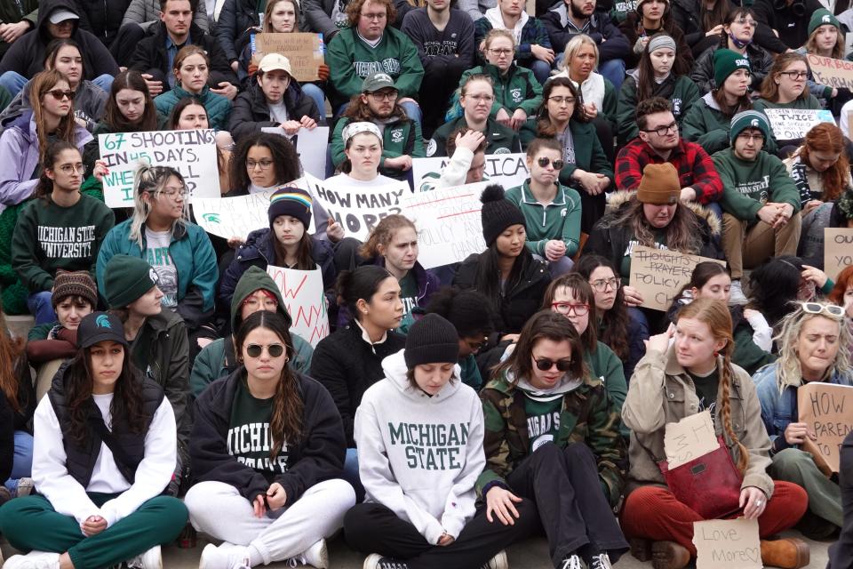 Current and former Michigan State students and their supporters attend a rally outside the state Capitol on Wednesday, two days after a gunman killed three students and critically wounded five others in a shooting spree.