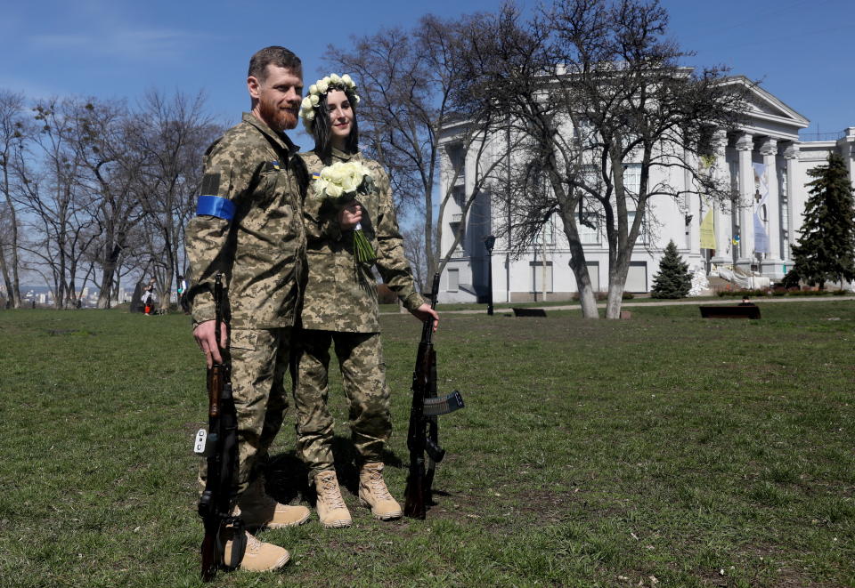Members of the Ukrainian Territorial Defence Forces Anastasiia (24) and Viacheslav (43) wait to attend their wedding ceremony, amid Russia's invasion of Ukraine, in Kyiv, Ukraine, April 7, 2022. REUTERS/Mykola Tymchenko