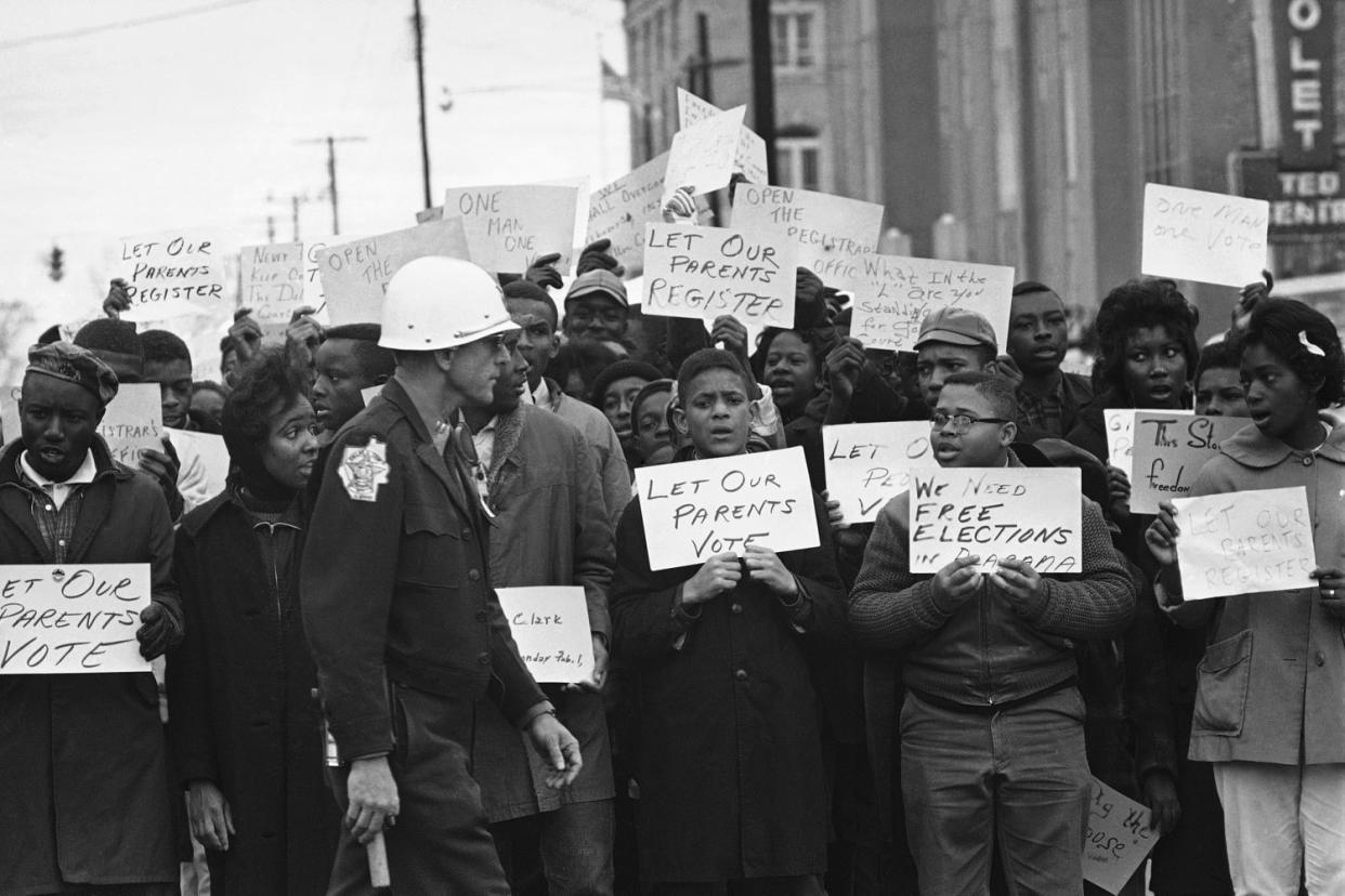 Image: Sign-carrying young African Americans sing and chant as they stage a demonstration at the courthouse (Bill Hudson / AP)