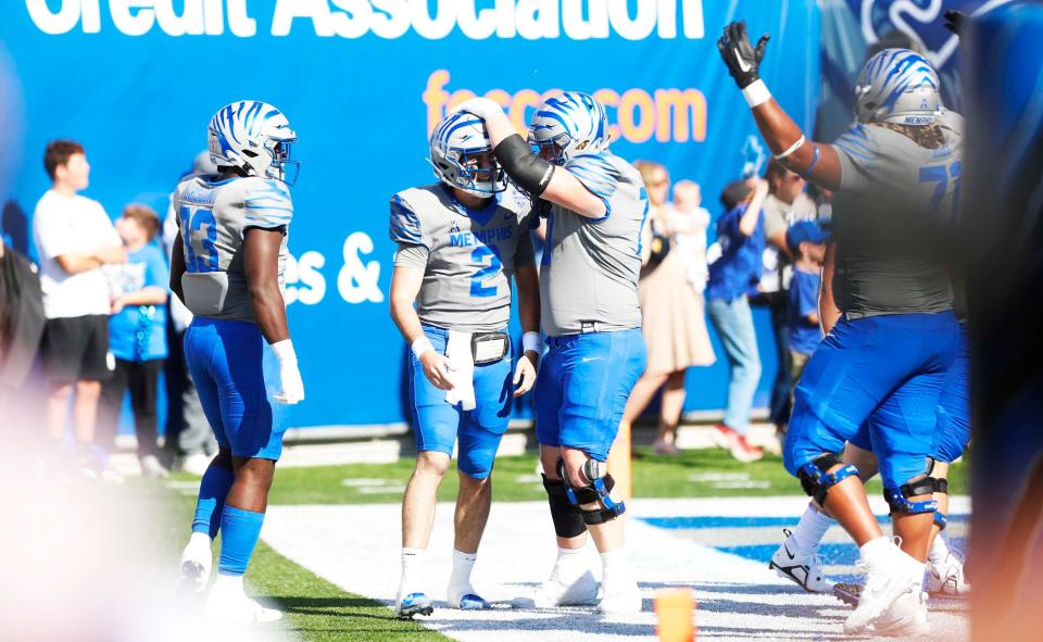 Memphis Tigers’ Seth Henigan (3) celebrates with teammates after he rushes for a touchdown against South Florida in their homecoming game on Saturday, November 04, 2023 at the Simmons Bank Liberty Stadium in Memphis, Tenn.