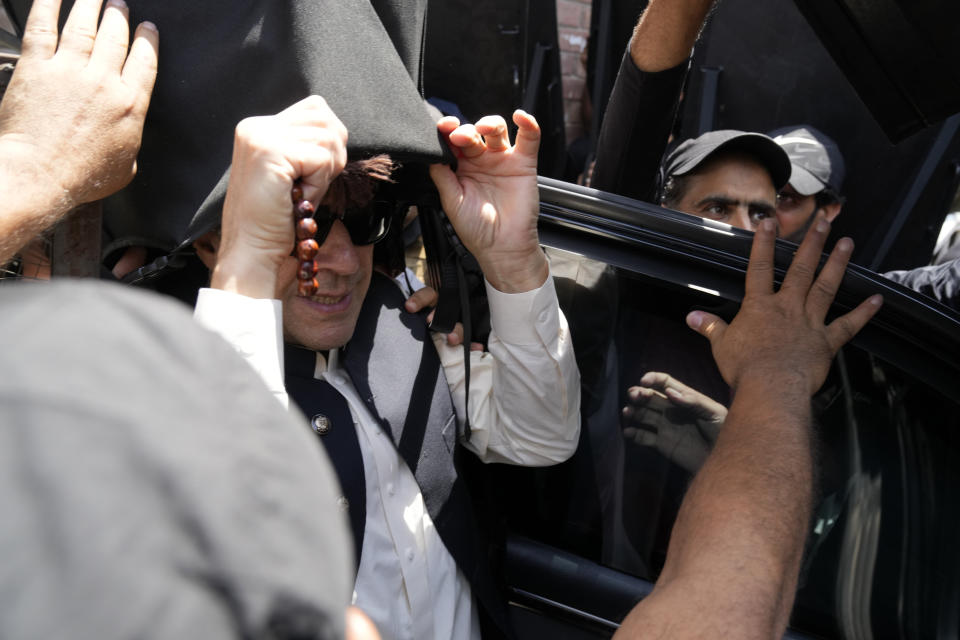 Former Pakistani Prime Minister Imran Khan, arrives to appear before a court in Lahore, Pakistan, Friday, May 19, 2023. Khan dialed down his campaign of defiance Friday, saying he would allow a police search of his residence over allegations he was harboring suspects wanted in recent violence and appearing before a court in his hometown to seek protection from arrest in multiple terrorism cases. (AP Photo/K.M. Chaudary)