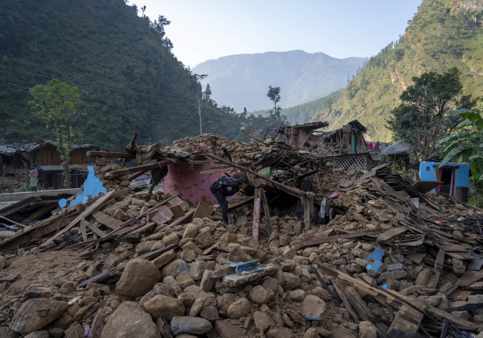 A survivor inspects his earthquake damaged house in Rukum District, northwestern Nepal, Monday, Nov. 6, 2023. The Friday night earthquake in the mountains of northwest Nepal killed more than 150 people and left thousands homeless. (AP Photo/Niranjan Shrestha)