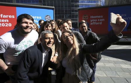 Sadiq Khan, Britain's Labour Party candidate for Mayor of London, poses for a selfie with supporters at Canary Wharf in London, Britain May 4, 2016. REUTERS/Paul Hackett