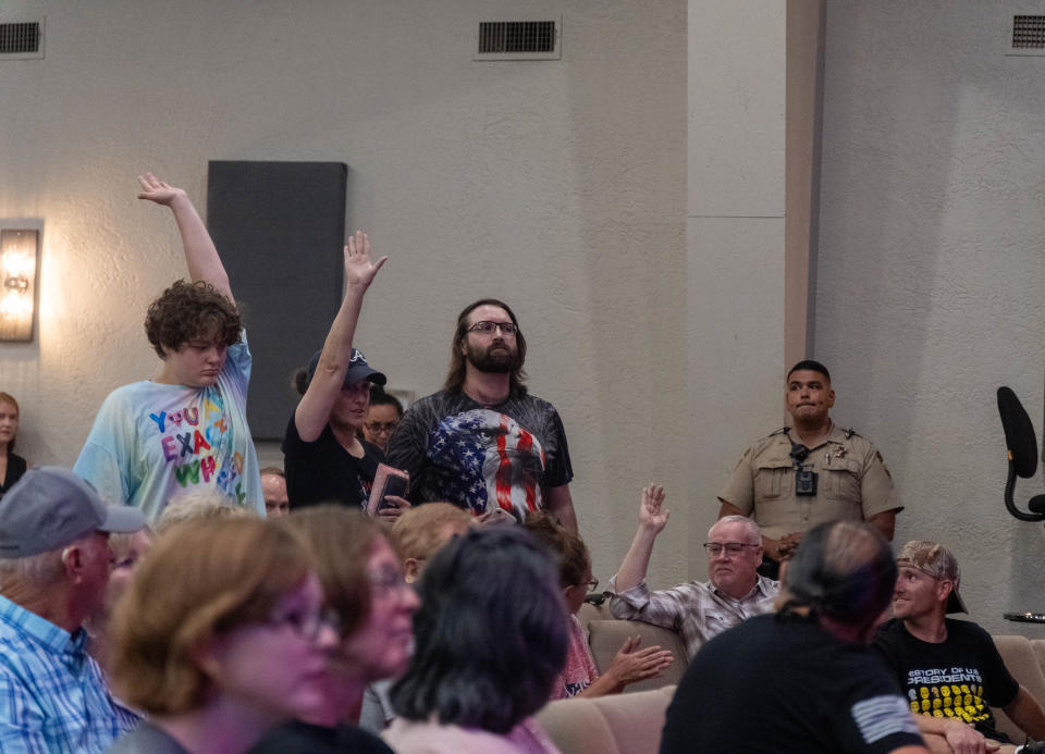 A crowd member grills Rep. Jackson on LGBTQIA+ rights as police look on at a tense moment of a town hall Tuesday conducted at the Arena of Life Church in Amarillo.