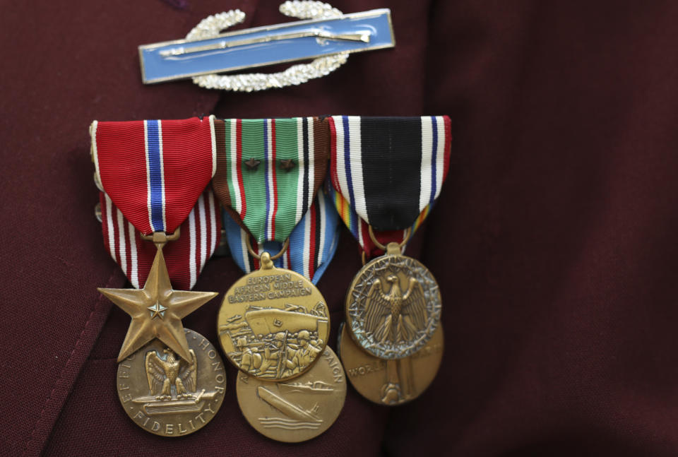 Harold Radish, 95, of the 90th division and a prisoner of war, shows his medals during an interview with the Associated Press Friday, Aug.23, 2019 in Paris. Radish arrived in Normandy a few months after D-Day, fought into Germany, and then was captured and held as a prisoner of war. As a Jew, he remains surprised and grateful to have made it out alive. Radish was part of a group of World War II veterans taking part in commemorations of the 75th anniversary of the Allied operation to liberate Paris from Nazi occupation. (AP Photo/Daniel Cole)