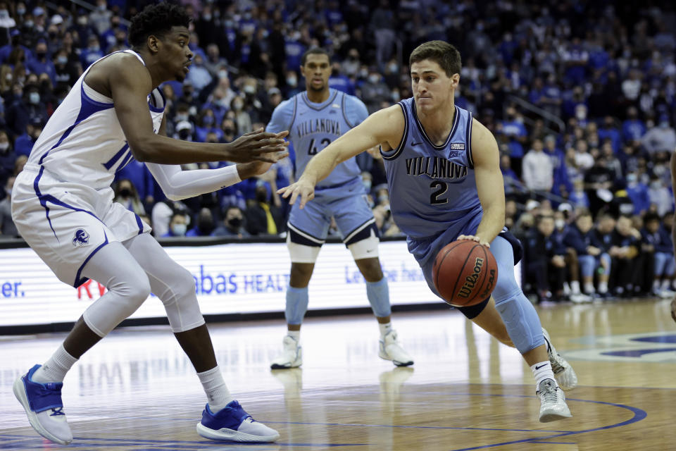 Villanova guard Collin Gillespie (2) drives to the basket past Seton Hall forward Alexis Yetna during the first half of an NCAA college basketball game Saturday, Jan. 1, 2022, in Newark, N.J. (AP Photo/Adam Hunger)