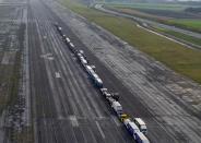 Some 150 trucks are parked at Manston Airfield during a test for a 'no-deal' Brexit, where 6,000 trucks could be parked at the airfield near Ramsgate in south east England, Monday, Jan. 7, 2019. The former airfield at Manston could be used as part of the government plan to park some 6,000 trucks to alleviate expected congestion at the channel ports, about 25 miles (40 Km) from the airfiled, caused by the reintroduction of customs checks on goods in the event of Britain making a no-deal withdrawal from the European Union at the end of March. (Victoria Jones/PA via AP)