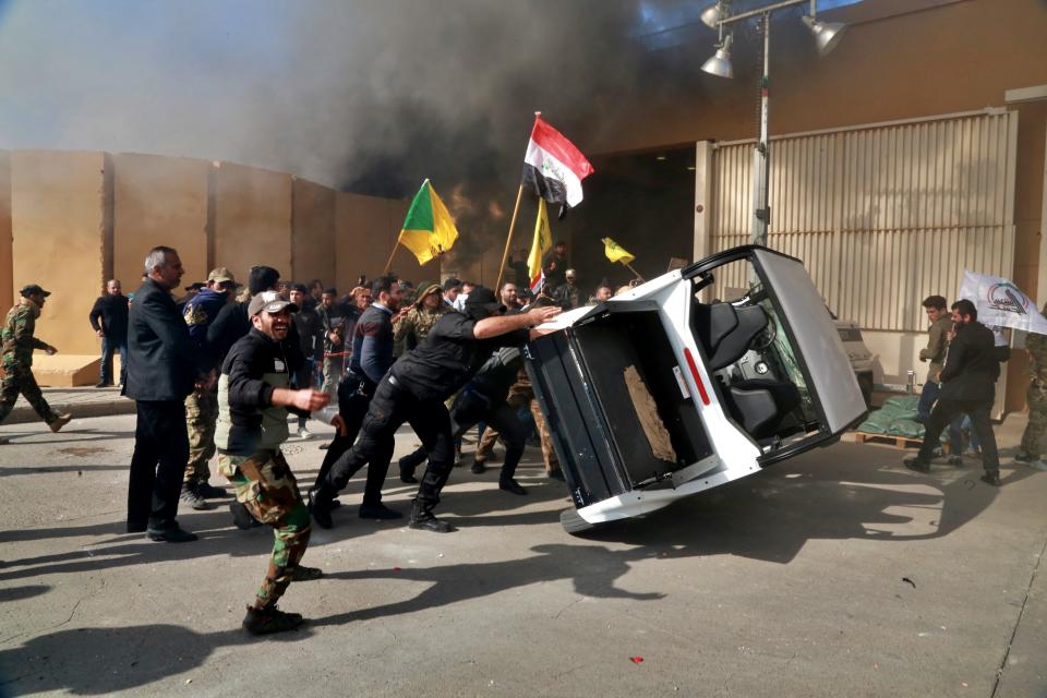 FILE - In this Dec 31, 2019, file photo, protesters damage property inside the U.S. embassy compound, in Baghdad, Iraq. Iran has had its fingers in Iraq's politics for years, but the U.S. killing of an Iranian general and Iraqi militia commander outside Baghdad has added new impetus to the effort, stoking anti-Americanism that Tehran now hopes it can exploit to help realize the goal of getting U.S. troops out of the country. (AP Photo/Khalid Mohammed, File)