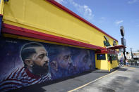 A street mural of the late rapper Nipsey Hussle is pictured near his closed The Marathon Clothing store, Thursday, June 30, 2022, in Los Angeles. The many murals of Hussle around Los Angeles speak to the late rapper's lasting legacy. (AP Photo/Chris Pizzello)