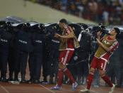 Equatorial Guinea's players dodge water bottles thrown by fans as police protect Ghana players during their semi-final soccer match of the 2015 African Cup of Nations in Malabo, February 5, 2015. REUTERS/Amr Abdallah Dalsh