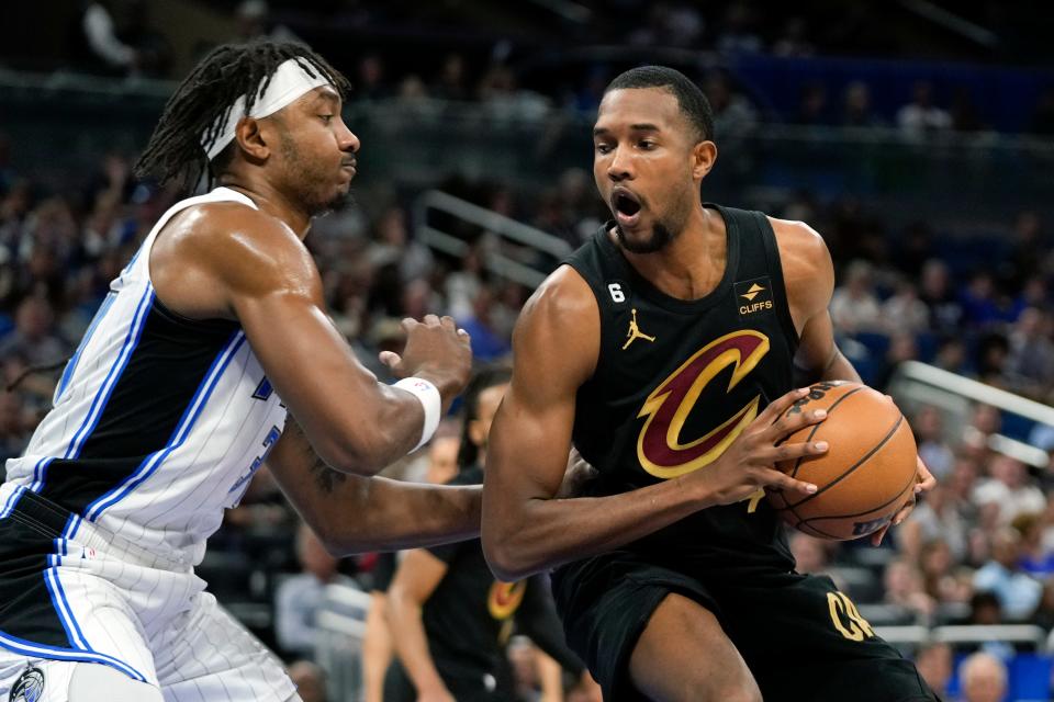 Cavaliers forward Evan Mobley looks for a way past Magic forward Wendell Carter Jr., left, Tuesday, April 4, 2023, in Orlando.