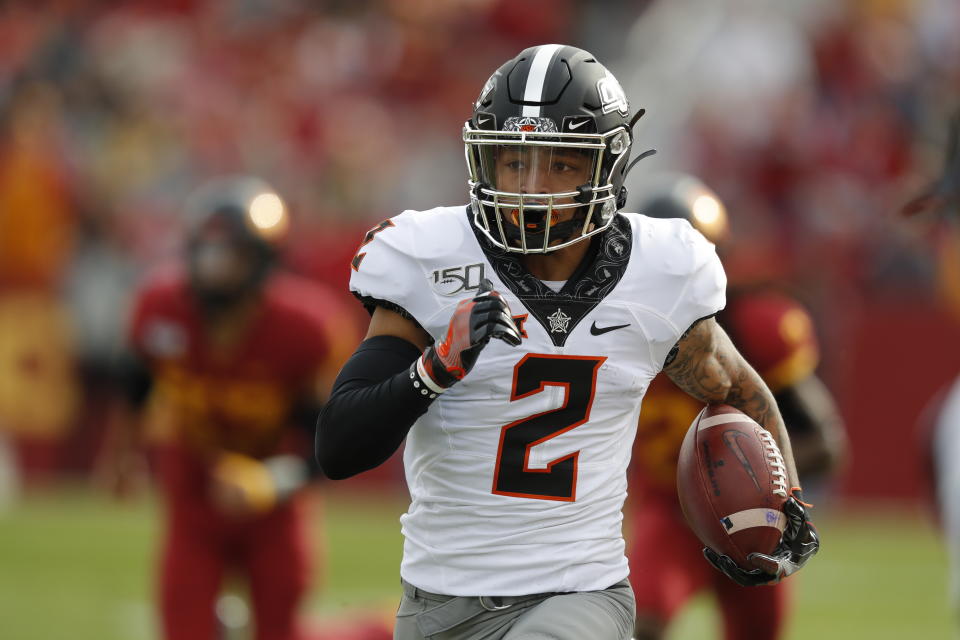 Oklahoma State wide receiver Tylan Wallace breaks free from Iowa State defense to score a touchdown during the first half of an NCAA college football game, Saturday, Oct. 26, 2019, in Ames, Iowa. (AP Photo/Matthew Putney)