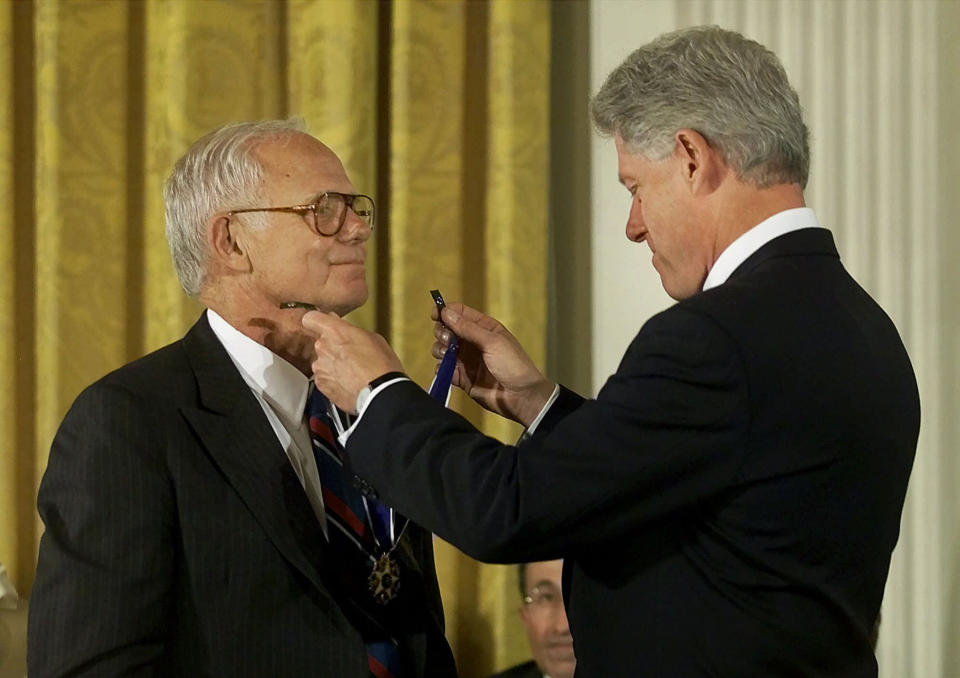 In an Aug. 9, 2000 photo provided by Johnson & Johnson, President Bill Clinton, right, awards former Johnson & Johnson CEO James E. Burke the Presidential Medal of Freedom, in Washington. Burke, who helped the company expand dramatically around the world and steered it through the Tylenol poisonings in the 1980s, died on Friday, Sept. 28. He was 87. (AP Photo/PR Newsfoto, Camera1 NYC)