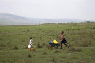 Children walk to the last tap with running water in their village after water to the other communal taps was cut off due to drought in Qwabe, north of Durban, South Africa. REUTERS/Rogan Ward