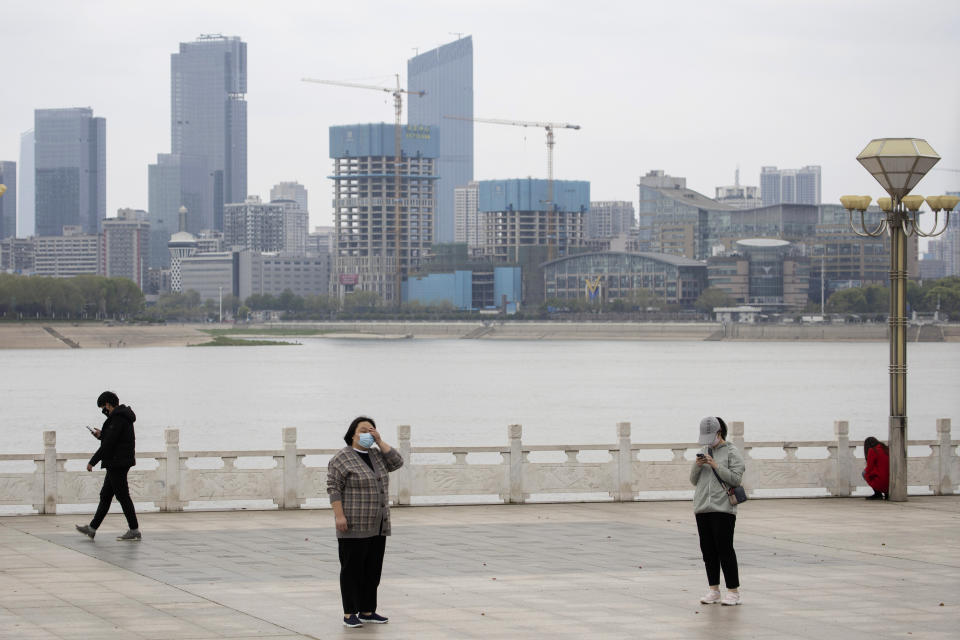 Residents observe social distancing at a park along the Yangtze River in Wuhan in central China's Wuhan province on Wednesday, April 1, 2020. Skepticism about China’s reported coronavirus cases and deaths has swirled throughout the crisis, fueled by official efforts to quash bad news in the early days and a general distrust of the government. In any country, getting a complete picture of the infections amid the fog of war is virtually impossible. (AP Photo/Ng Han Guan)