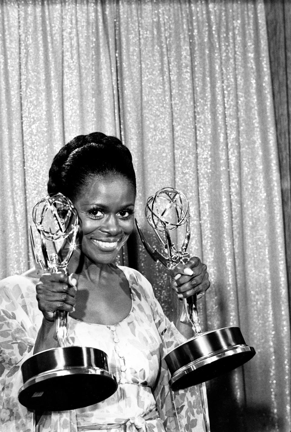 Cicely Tyson poses in 1974 with her Emmy statuettes for actress of the year and best lead actress in a television drama for a special program for her work in "The Autobiography of Miss Jane Pittman."